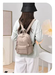 Mini nylon backpack for women, lightweight waterproof casual daypack with multiple pockets.