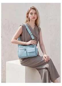 Retro soft leather multi-pocket crossbody bag for women with wide striped webbing shoulder strap.