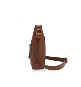 Brown faux leather crossbody bag side view showing tassel and adjustable strap details.