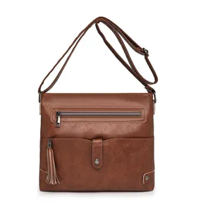 Brown PU leather crossbody bag detail featuring stylish tassel and zipper pocket design.