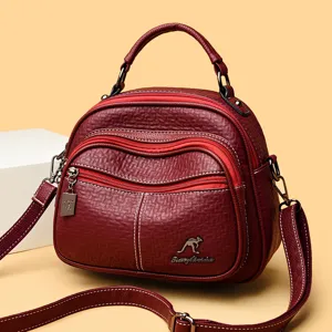 Women's vintage burgundy leather shoulder bag with top handle, multi-zipper and stylish design.