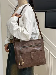 Women retro brown PU leather crossbody shoulder bag with stylish tassel and front pocket design.