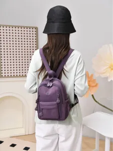 Stylish mini nylon backpack for women, lightweight waterproof small casual daypack bag.