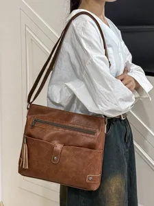 Women's stylish PU leather cross-body shoulder bag with tassel charm, perfect for daily wear.
