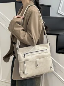 Trendy tassel crossbody bag for women, stylish PU leather shoulder bag for daily casual use.
