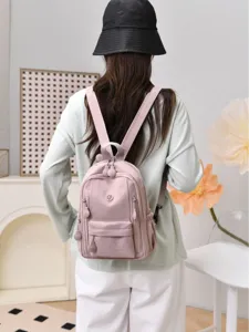 Women mini nylon backpack casual lightweight multi-pocket dual-use daypack in pink.