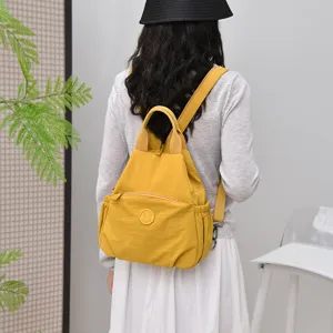 Multi-functional lightweight yellow nylon backpack for women, casual travel and daily commute.