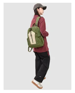 Detailed view of lightweight outdoor backpack, green and beige design for travel and hiking.