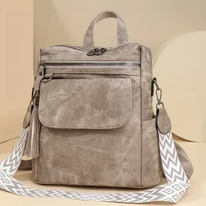 Detail shot of women's retro tassel backpack with geometric straps and large daily capacity.
