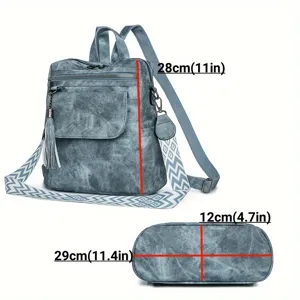 Detail view of blue leather backpack showing size dimensions and bottom structure clearly.