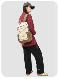 Detailed view of the color-blocked casual backpack with durable straps and bungee cords.