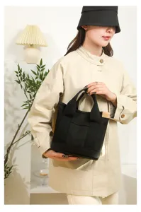 Minimalist black canvas handbag for women, casual daily tote bag with double handles.