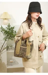 Detail view of a stylish Japanese style leopard print canvas tote bag, handheld bento bag.