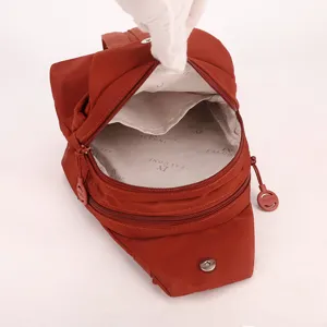 Red nylon casual sling bag with zipper pockets and stylish interior lining for daily commute.