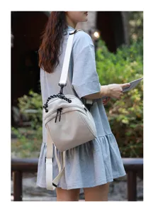 Detail view of a chic mini shell backpack worn by model, versatile and cute daily bag.