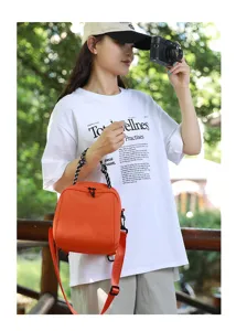 Detailed shot of cute orange mini backpack, versatile 3-in-1 design with braided handle.