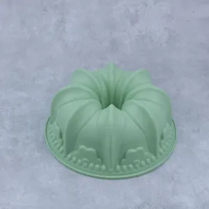 Silicone bundt cake mold detail, green crown baking pan close up for kitchen pastry making.