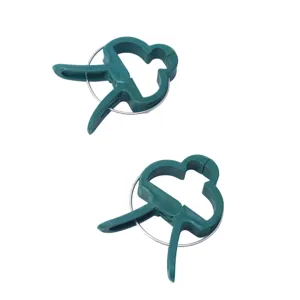 Detail view of green plastic plant clips, sturdy spring design for garden support.