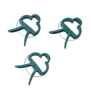 Close-up detail of green plastic plant clip with metal spring for garden support.