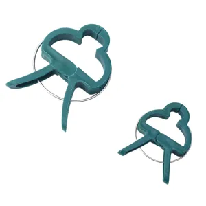 Green plastic garden plant clips detail, durable spring clamps for supporting tomatoes and flowers.