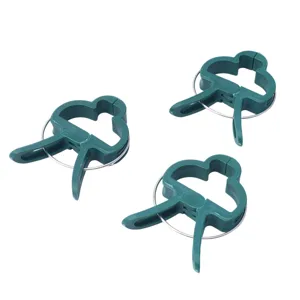 Green plastic plant clips for garden tomatoes and flowers, durable support clips for climbing plants.