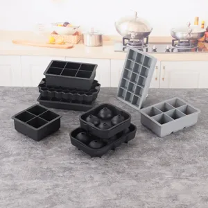 Silicone ice cube tray set with various shapes like spheres and squares for whiskey and drinks.