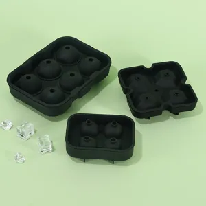 Detail view of black silicone ice cube trays, flexible sphere and multi-cavity molds for whiskey.