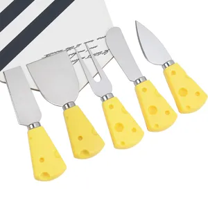 Detail view of 5-piece stainless steel cheese knife set with cute yellow cheese shaped handles.