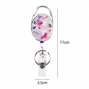 Retractable badge reel with floral pattern oval case, durable zinc alloy carabiner clip.