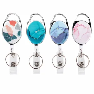 Oval retractable badge reel with key ring, metal carabiner clip, and stylish patterns.