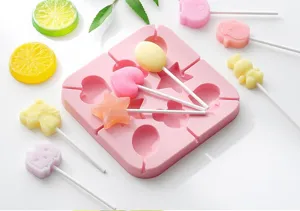 Silicone lollipop mold detail view, pink square baking tool with multi-shape cavities.
