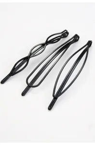 Close-up of minimalist black geometric hair clips, sleek metal bobby pins for styling.