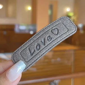 Leather square hair clip for women, simple chic hair accessory with love letter and heart design.