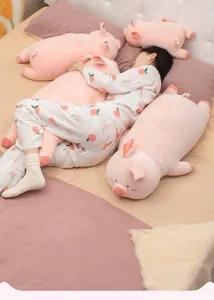 Cozy bedroom detail view showcasing soft pink plush pig hugging pillow companion for sleep.
