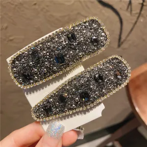 Exquisite rhinestone hair clip detail featuring sparkling crystals and sparkling metal edges.