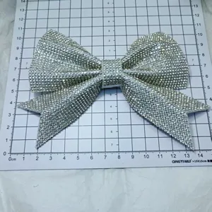 Rhinestone bow shoe patch detail view, shiny crystal decorative accessory for bags and hair.