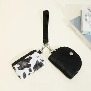 Two-in-one womens wrist bag set featuring cow print coin purse and black mini pouch daily use