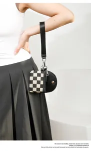 Two-in-one checkerboard wristlet bag detail, portable mini coin purse and card holder design.