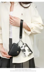 Two-in-one women's wrist bag with coin purse and cow print mini pouch for daily use.