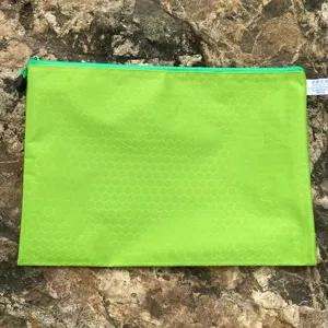 Close-up detail of green hexagonal pattern A4 waterproof zipper file document storage bag.