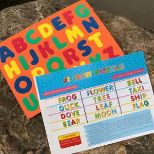 Colorful foam alphabet puzzle board set with educational cards for early learning.