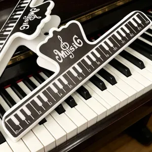 Piano music book clip page holder, black and white piano keys design for students and musicians.