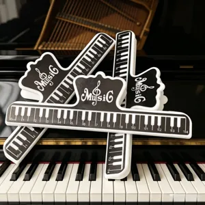 Black and white piano book clip with ruler scale, durable music sheet holder for students.