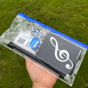 Kit de papeterie trousse transparente avec carnet, crayons, règle, gomme et taille-crayon pour école.