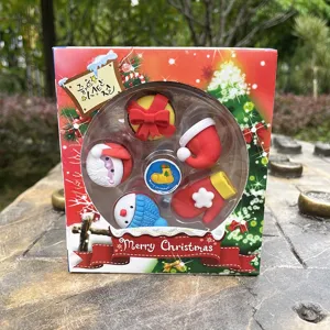 Close-up detail of cute Christmas eraser set featuring assorted festive shapes like Santa and snowman.