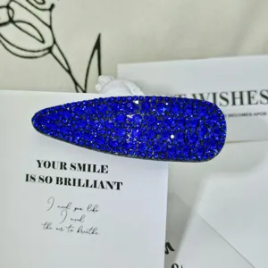 Detailed shot of dark blue rhinestone waterdrop hair clip, elegant side hairpin accessory.