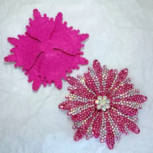 Close-up of handmade rhinestone shoe flower accessory, pink crystal flower decor detail.