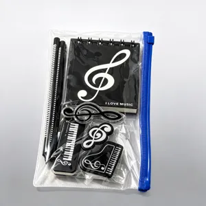 Details of the music themed stationery set featuring notebook, pencils, and cute piano clips.
