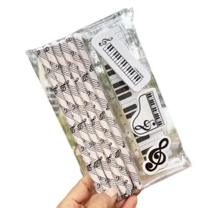 Creative music stationery set including pencils, ruler and erasers with piano keyboard patterns.