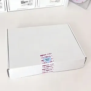 White photocard packing airplane box detail shot showing clean design and secure sealing sticker.